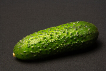 Green cucumber on a black background. Vegetables