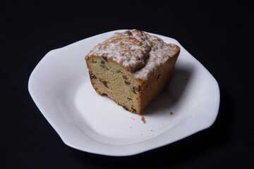 Cupcake with raisins on a white plate 