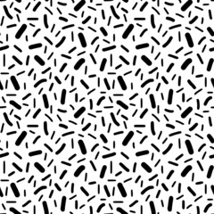 Seamless pattern. Black dashes in chaotic order on a white background.	