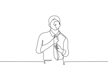 man stands in shirt and straightens tie - one line drawing vector. concept of buying clothes tie, office work
