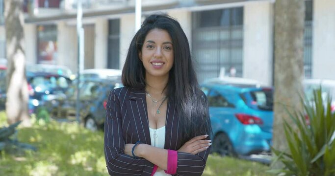 north african businesswoman crosses her arms staring at camera- carrer, success