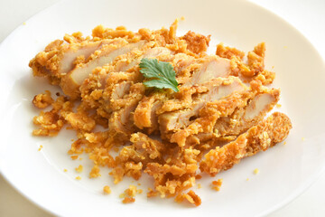 Fried chicken slices on a white plate. 
