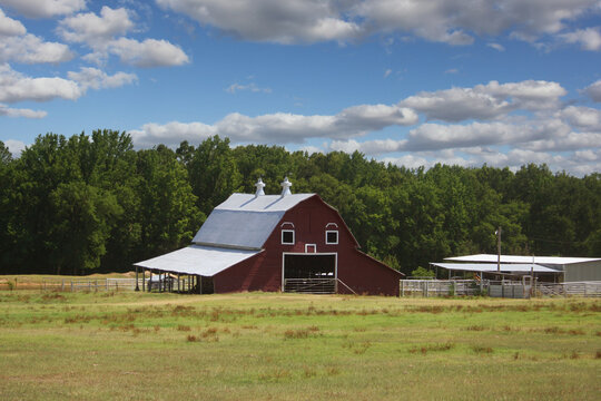Red Barn located on Farm in East Texas with Blue Sky and Clouds