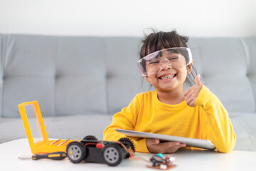 Inventive kid constructing robot cars at home