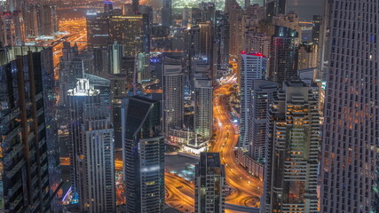 Skyline view of Dubai Marina showing canal surrounded by skyscrapers along shoreline night to day timelapse. DUBAI, UAE