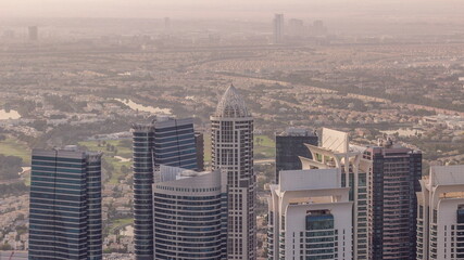 Jumeirah Lakes Towers district with many skyscrapers along Sheikh Zayed Road aerial timelapse.