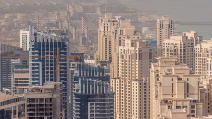 Aerial view of JBR and Dubai Marina skyscrapers and luxury buildings timelapse from above