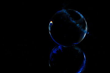 Abstraction of a mirrored sphere on a dark background