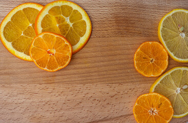 mugs of orange and lemon on a wooden board top view copy space