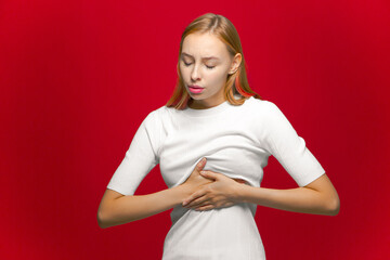 Sick young girl pressing on chest suffering sudden ache, heart attack, cardiac problems,...