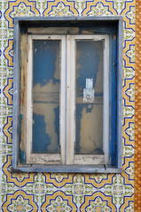 Fototapeta na wymiar Close Up of Old Window in Ceramic Tiled Wall 