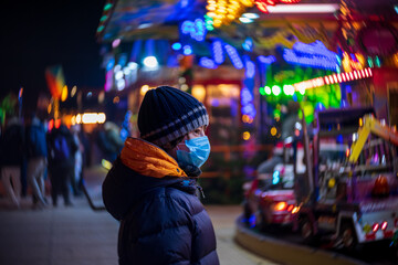 Fototapeta premium A teenager at a Christmas market during COVID-19 pandemic restrictions.