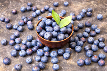 Organic fresh blueberries in a wooden bowl