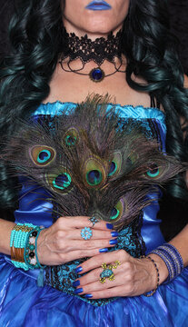 Woman in Blue Corset With Green and Black hair and peacock feathers