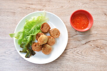 deep fried mashed crab meat and pork roll Chinese food on plate dipping sweet plum sauce