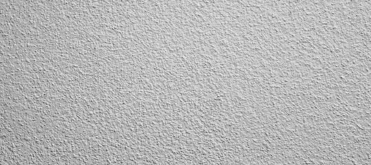 the wall is painted with gray paint with a visible texture