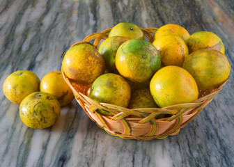 A basket of tangerines on the table