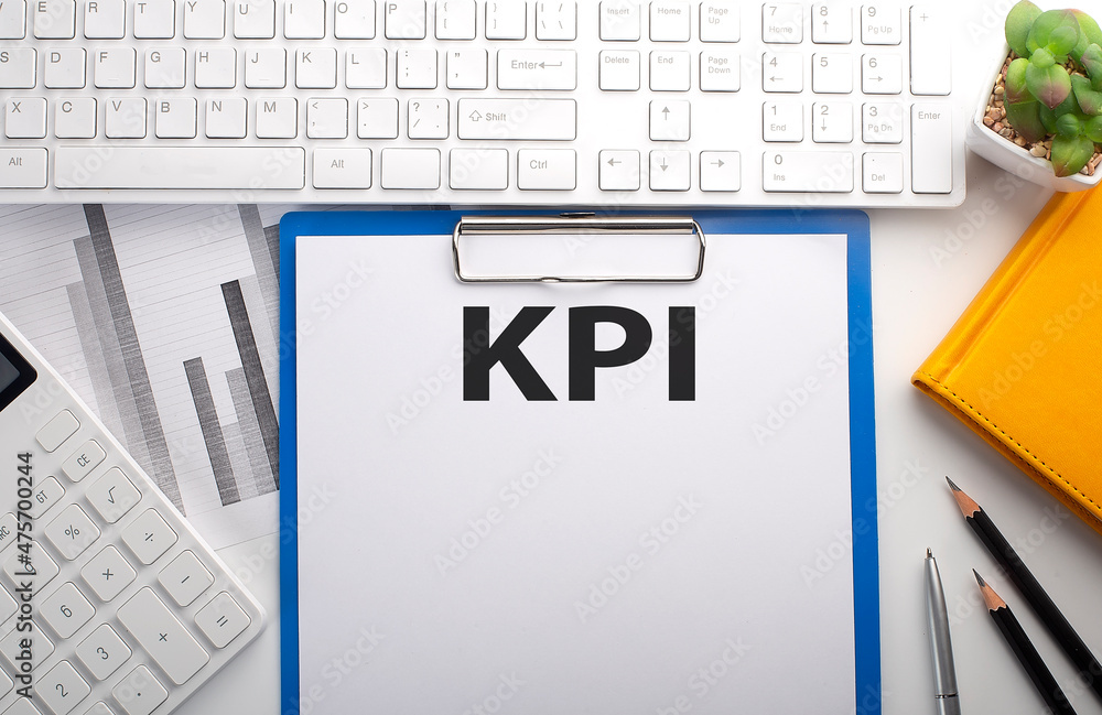 Aufkleber kpi written on paper with keyboard, chart, calculator and notebook