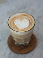 a glass of hazelnut latte on a ceramic table