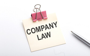 COMPANY LAW text on sticker with pen on the white background