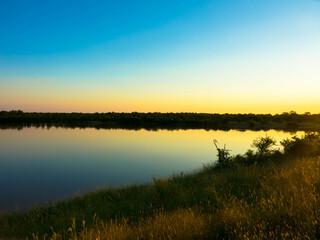 Fototapeta na wymiar Magical sundown on the shore of a lake in South Africa, Kruger national park