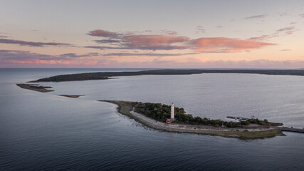 Coast and lighthouse Lange Erik on north coast of the island of &Ouml;land in the east of Sweden from above during sunset.