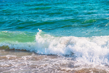 Soft wave of blue sea on sandy beach.