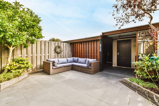 Amazing courtyard design with wicker sofas and lots of greenery