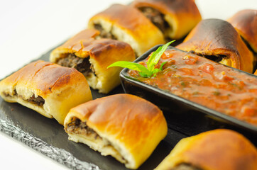 Patty's pies stuffed with minced meat, mushrooms and onion, served with sauce