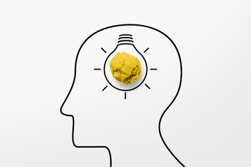 Paper scrap ball yellow colour and light bulb in head human symbol. Creative idea concept.