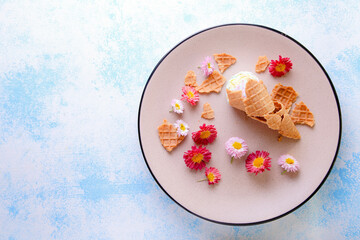 Beautiful composition with ice cream and flowers on a blue background