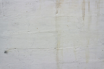 Old wall painted with white paint with the texture of a large brick.   