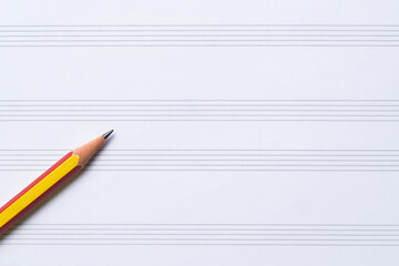 A pencil on the music sheet , musical concept