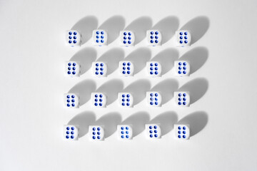 Volumetric dice on a white background, evenly standing objects in a line, a cube