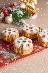 Christmas baking cupcakes with snowflake pattern with Christmas decor.