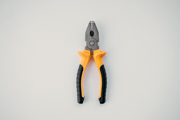 Closed pliers lie on white isolated background, tool for repair work