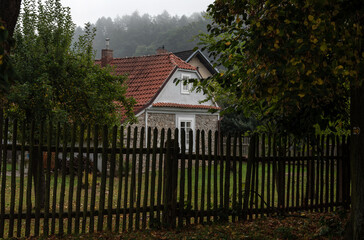Fototapeta na wymiar beautiful village house behind the fence