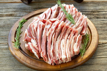 Raw lamb ribs on wood background.Spices and lamb ribs close-up. Horizontal view