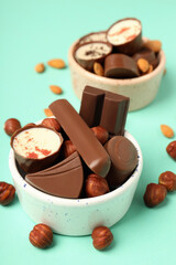 Concept of sweets with chocolate candies on mint background