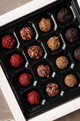 Concept of sweets with chocolate candies on textured background