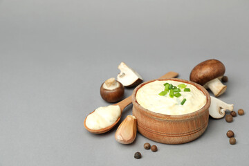Concept of tasty food with mushroom sauce on gray background