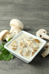 Concept of tasty food with mushroom sauce on gray wooden background