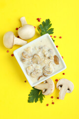 Concept of tasty food with mushroom sauce on yellow background