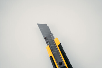 Open clerical knife lies on a white isolated background, horizontal photo