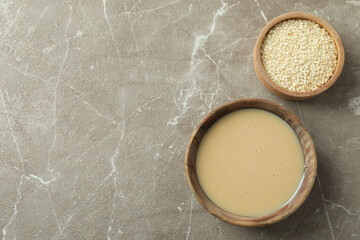 Concept of tasty food with tahini sauce on beige textured background