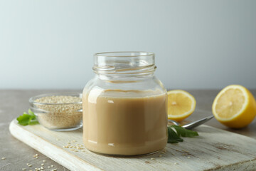 Concept of tasty food with tahini sauce on beige textured table