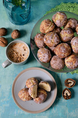 Cookies, cappuccino, nuts on a turquoise background. View from above.