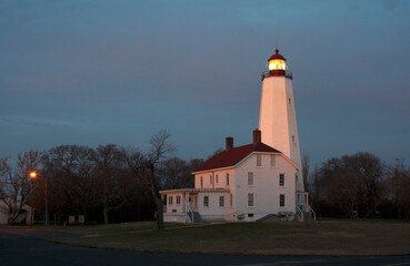 Lighthouse in Sandy Hook, New Jersey, at dusk, with the light turned on -55