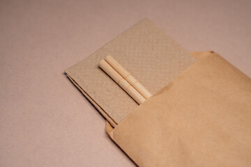 close-up of chinese sticks in craft paper packaging on beige background