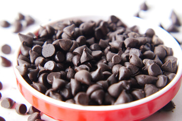 Chocolate chips spilling from a plastic packet,